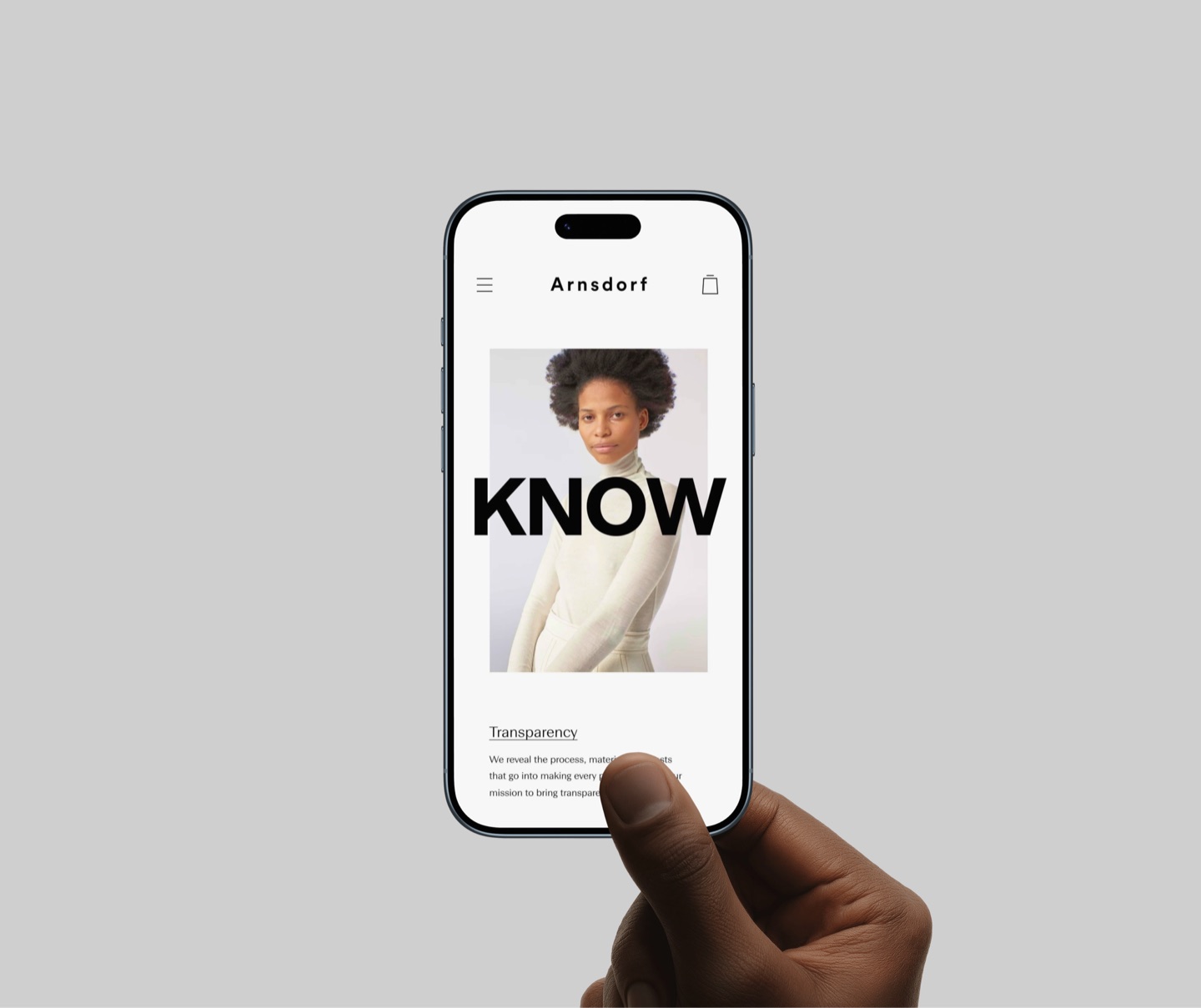 Hand holding a phone showing the Arnsdorf mobile site: the word Know over a model, introducing Transparency