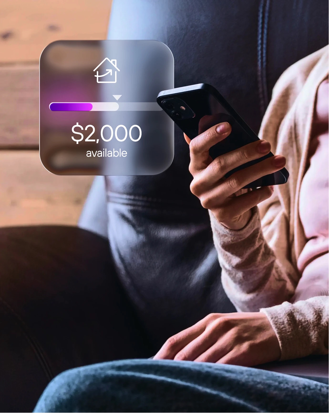 Person on a sofa using their phone, with a Kismet budget card overlaid showing $2,000 available