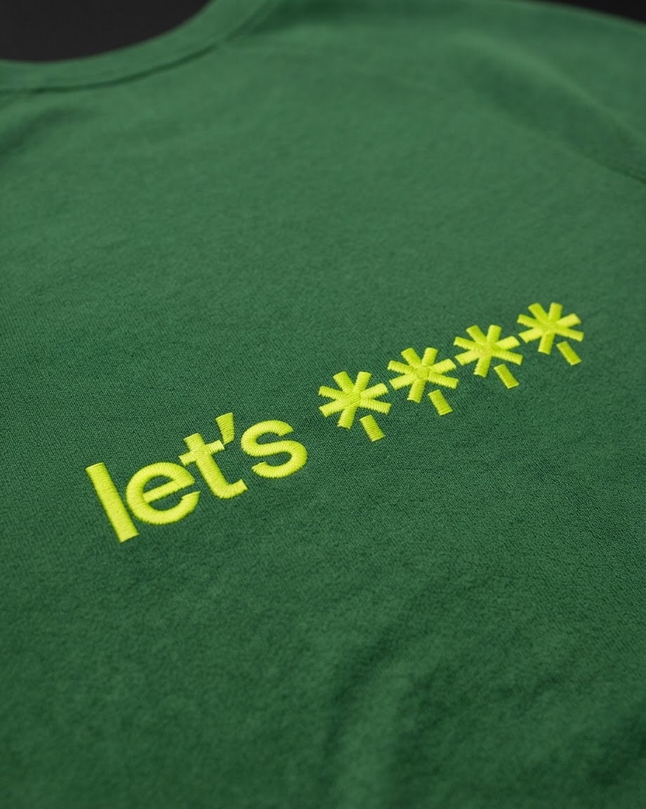 Close-up of a green Linktree sweatshirt embroidered in lime: let's followed by four asterisk logos