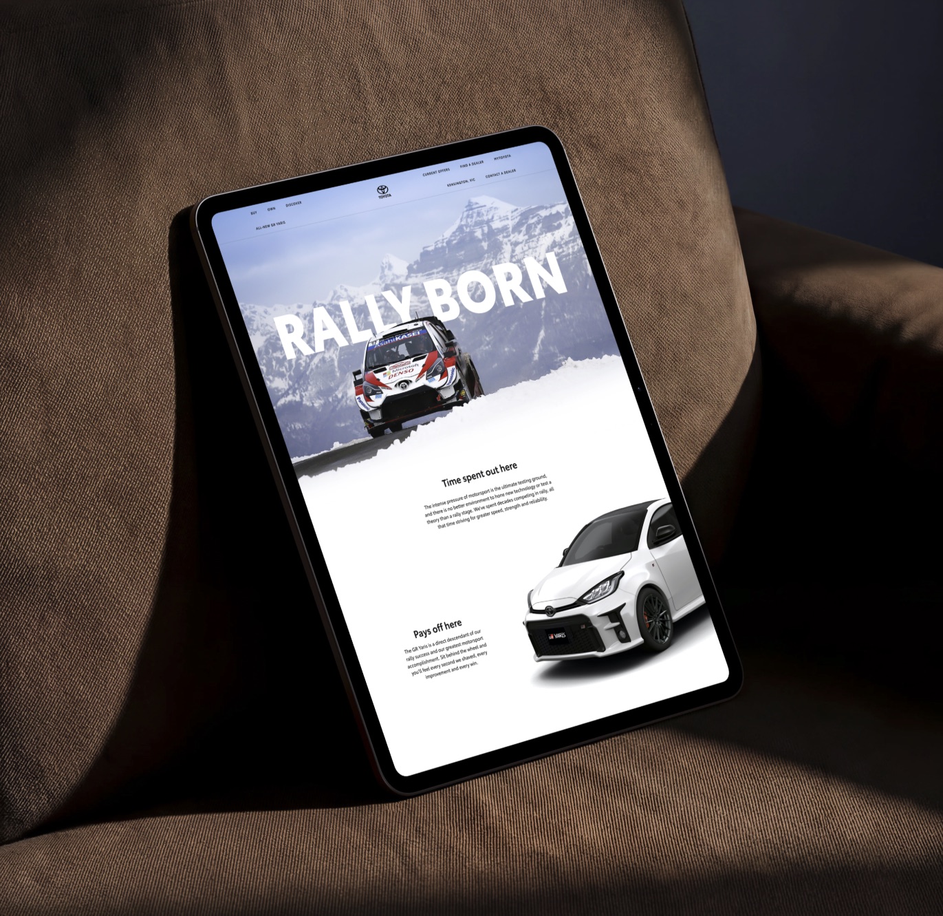 Tablet showing the Toyota GR Yaris page, Rally Born, with a rally car in snowy mountains above the road car
